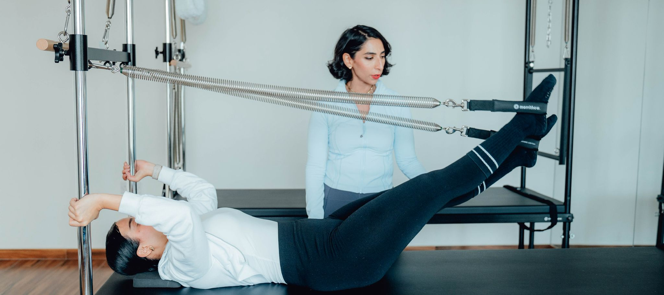 Women practicing Pilates with instructor